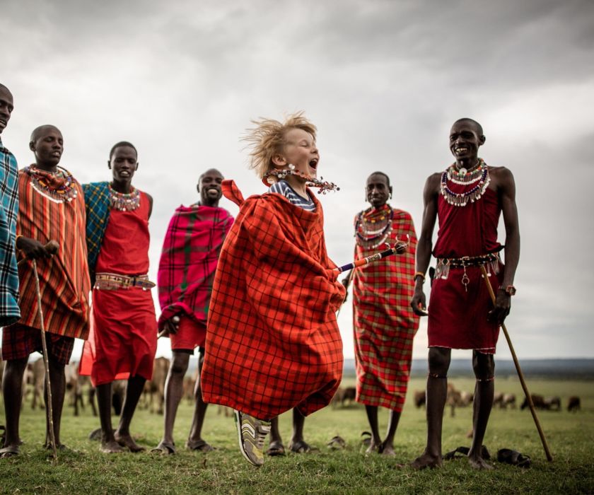 Maasai tribe standing in front of wildebeest